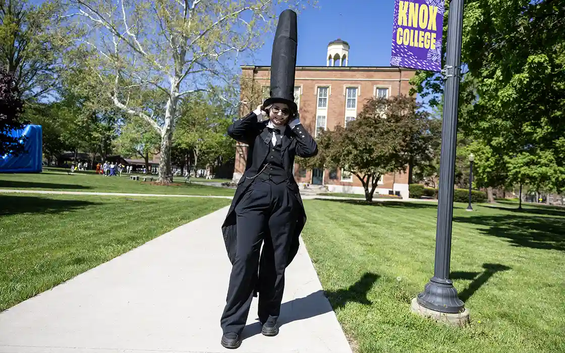 A student dressed up as Abraham Lincoln with a very tall hat.