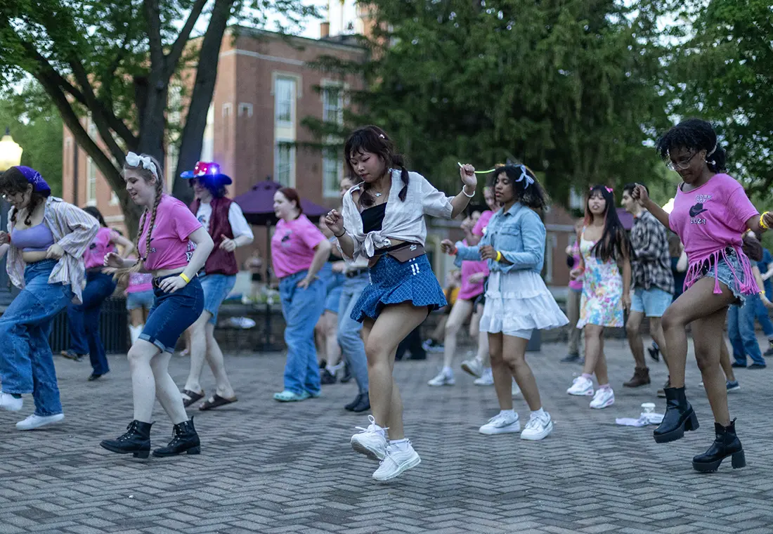 A large group of students dancing outside on the Gizmo Patio.