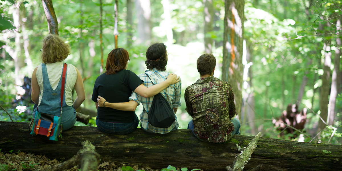 Students gather in the forest at Green Oaks, to view art proejcts during Green Oaks Term.