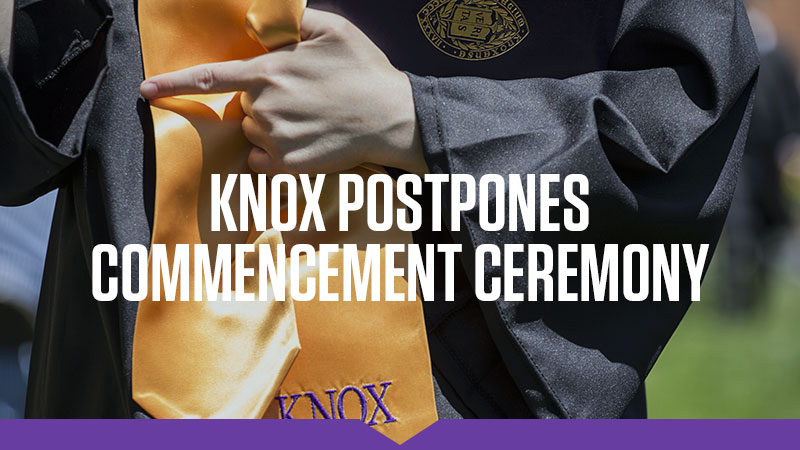 Knox postpones Commencement ceremony: Closeup on a student in Commencement regalia, including a gold satin sash with "Knox" embroidered in purple