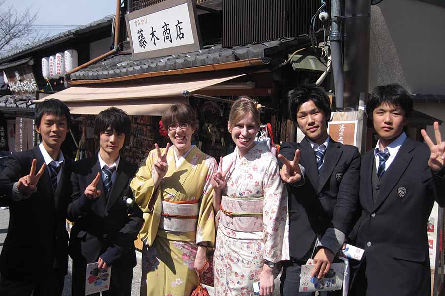 Knox students wearing traditional Japanese clothing pose with local high school boys during Japan Term.