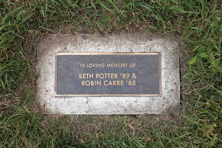 A plaque under the tree "In Loving Memory of Better Potter ’89 & Robin Carre ’85.