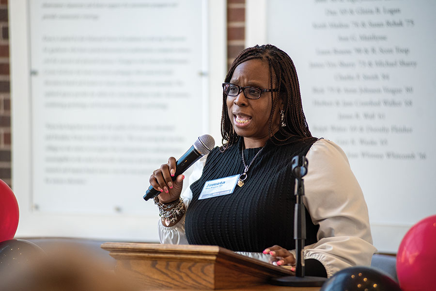 Jameta Rodgers speaking at a podium. 