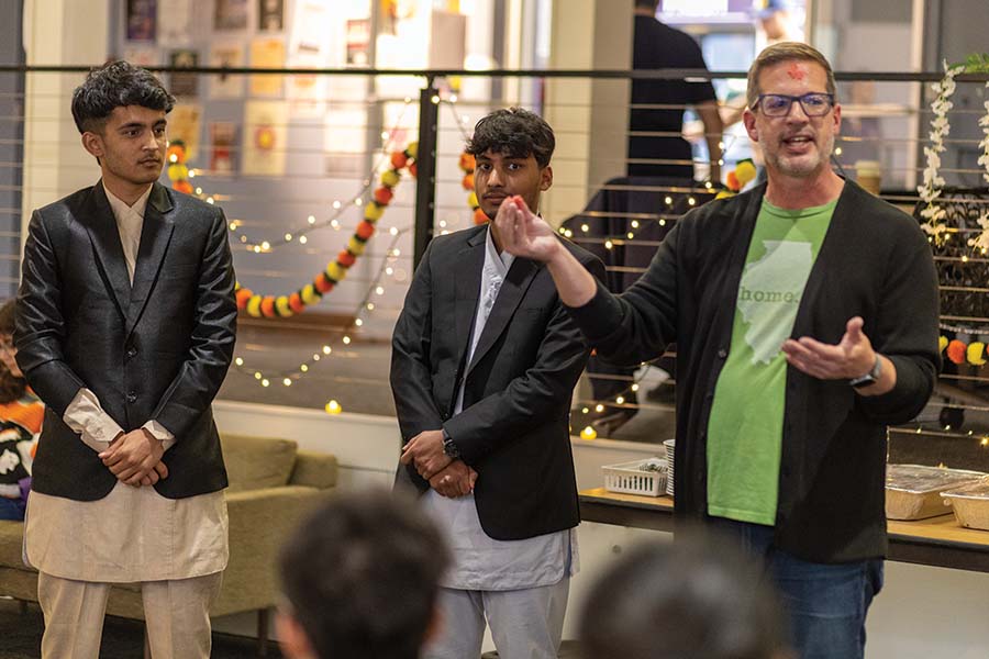 Associate Professor of English Chad Simpson speaks during a Dashain Tika ceremony with students in Post Lobby.