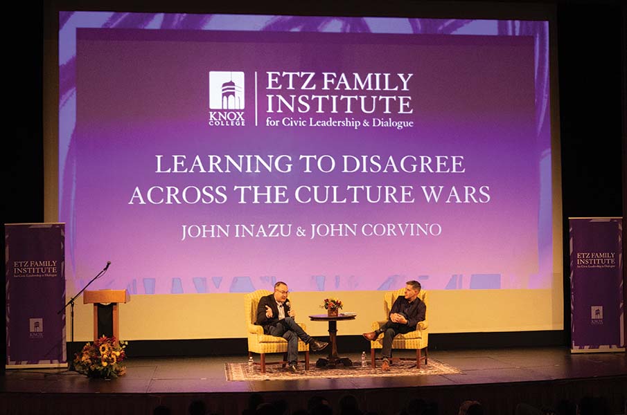 Professors speak on stage at the Orpheum Theatre.