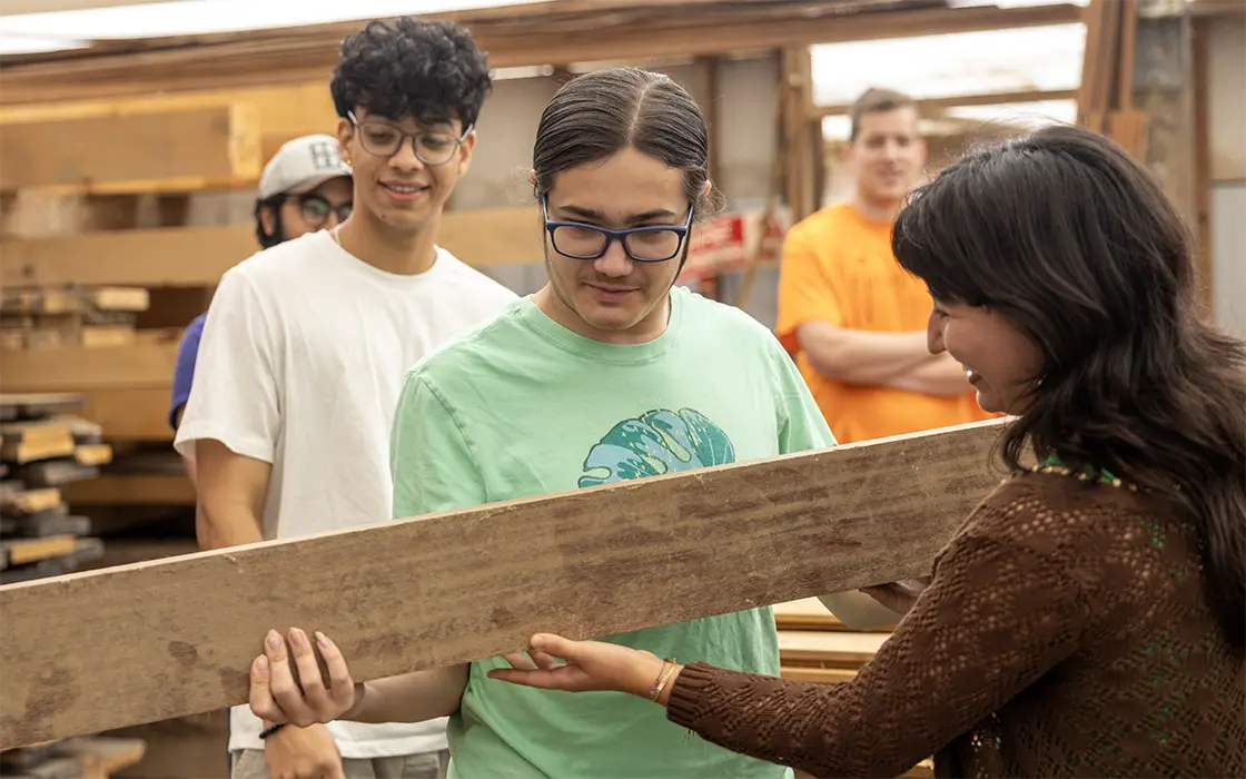 A student is handed a piece of lumbar.