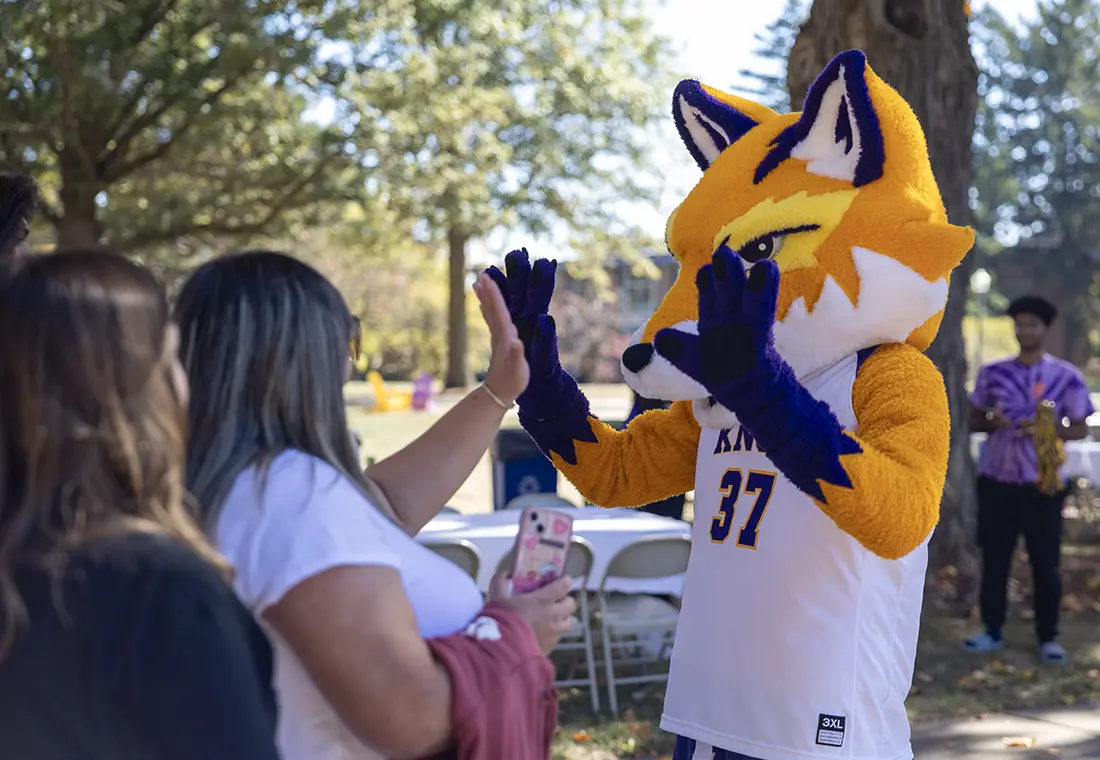 A student high-fives Blaze, the Knox mascot.
