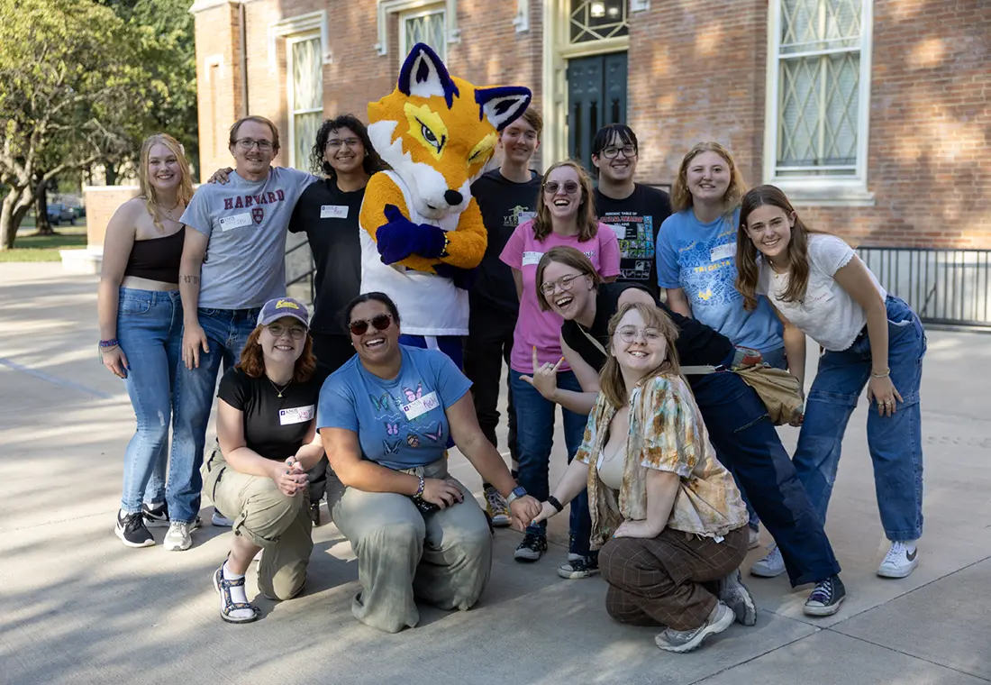 A group of Knox community members pose with Blaze, the Knox fox mascot, outside of Old Main.