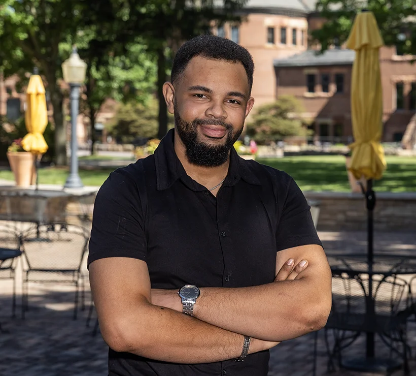 Taylor standing outside on the Gizmo Patio and smiling to the camera.