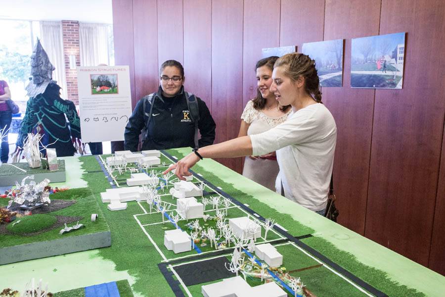 Knox College students discuss a model of campus, a landscape design created for an Open Studio art project.