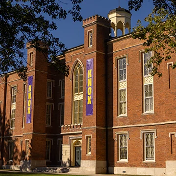 Sun shines on the south side of Knox College's Old Main.