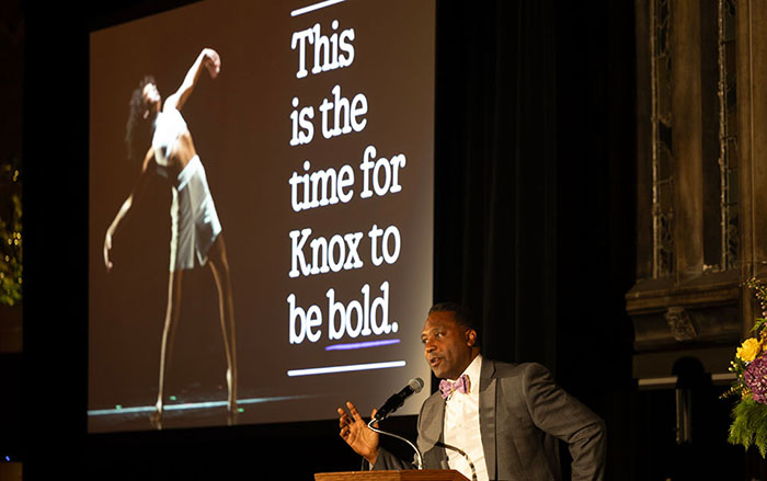 Knox President C. Andrew McGadney at a podium with a slide to his left that reads "This is the time for Knox to be bold."