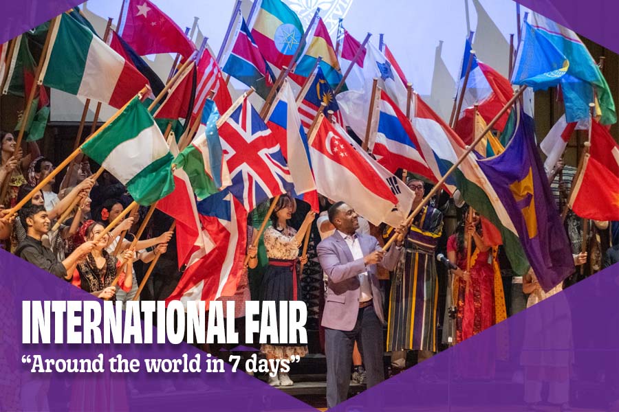 Image of Knox College President, C. Andrew McGadney, waving Knox flag among many students waving international flags