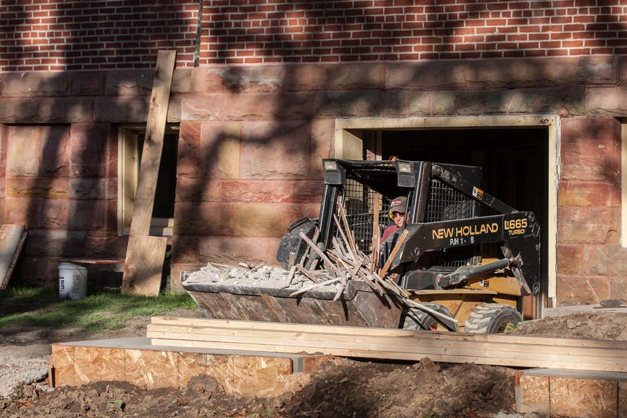 Construction waste removal during Alumni Hall renovation.