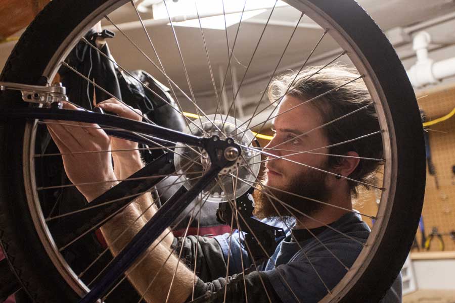 Knox College student working in campus bike shop