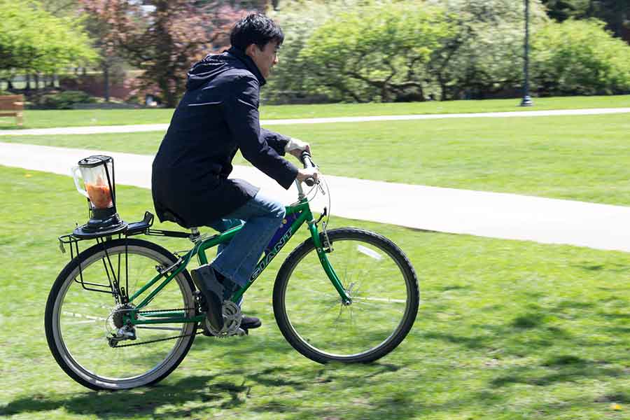 A student makes a smoothie using a bicycle